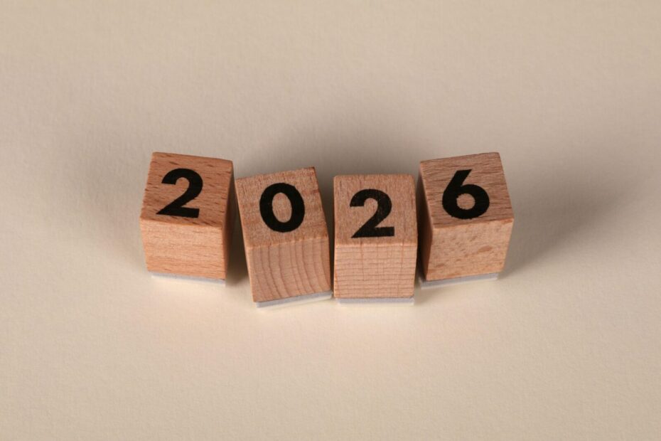 Wooden cubes forming the year 2026 on a neutral background.