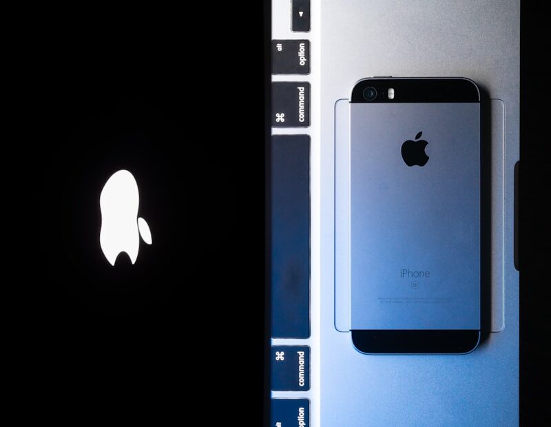 an image of an iphone next to a laptop